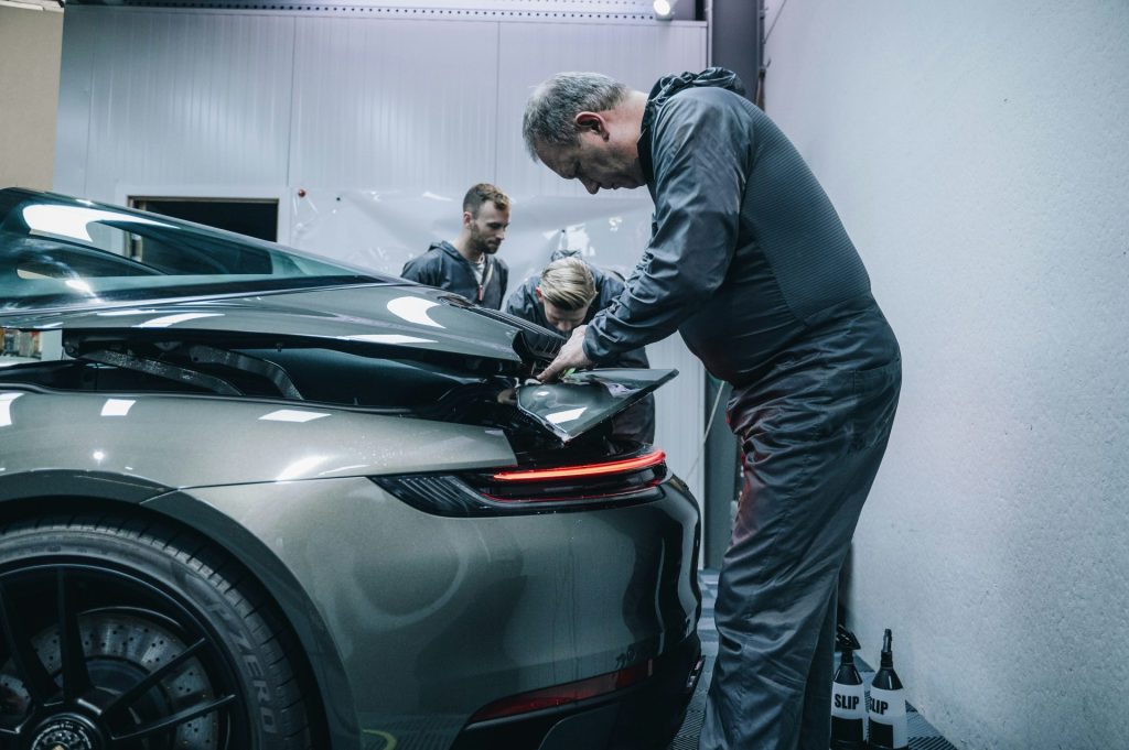 a man working on a car in a garage